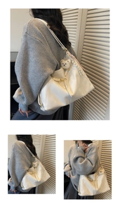 Detail of off-white leather tote bag with plush bear charm and woven rope strap