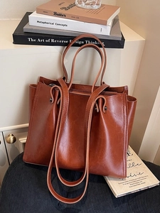 Caramel brown large tote bag in vintage shiny leather with dual handles and zip closure