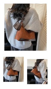 Detailed close-up of brown suede and leather stitching on retro hobo shoulder bag