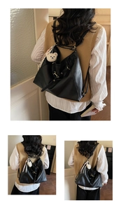 Detail of black faux leather tote with adjustable straps and plush bear charm