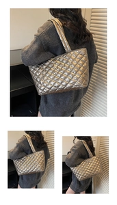 Close-up of silver quilted puffer tote bag with metallic texture and padded straps