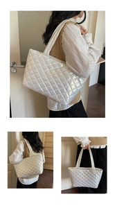 Macro shot of silver quilted tote bag showing puffer rhombic pattern and metallic texture