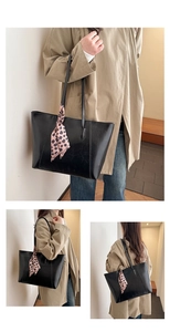 Close-up of black tote bag featuring fine leather texture and leopard print silk scarf
