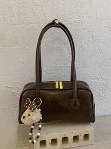 Vintage dark brown faux leather underarm bag with a cute plush dog charm and gold zippers