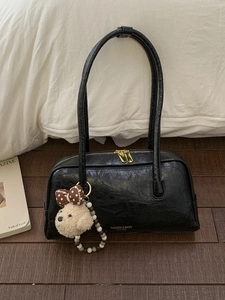 Retro black leather underarm bag with puppy charm and golden zipper details