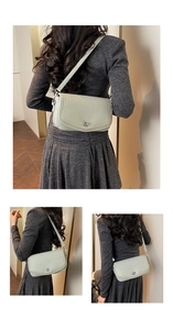 Detail view of light green pebbled leather shoulder bag with silver turn-lock closure