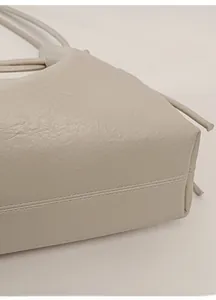 Macro detail of high-quality pebbled leather base with reinforced double stitching