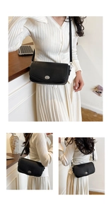 Detail of black pebble leather shoulder bag showing the silver metal twist lock closure