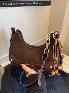 Retro brown crescent hobo bag with gold chain strap and wooden bead tassel detail