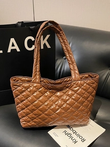 Brown quilted rhombus tote bag in glossy nylon on a leather sofa with chic aesthetic
