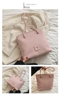 Detail of pink pleated tote bag featuring vertical texture and soft square logo branding