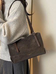 Retro dark brown faux leather tote bag with slim shoulder straps and gold branding