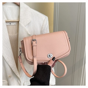 Close-up of pink litchi grain leather shoulder bag featuring a silver metal twist lock