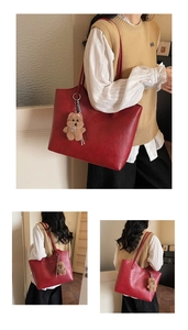 Detail of red textured PU tote bag featuring a cute brown bear plush pendant charm