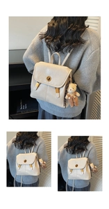 Detail of cream leather backpack with vintage gold twist lock and a cute bear charm