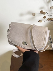 Chic beige lychee grain leather crossbody bag with silver metal swivel lock for women