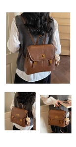 Detail view of vintage brown leather backpack with gold buckle and plush bear charm