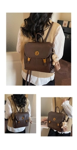 Detail view of a vintage dark brown leather backpack featuring a gold-tone twist lock closure