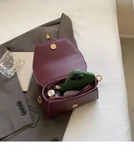 Macro view of burgundy leather bag interior showing spacious capacity for phone and cosmetics