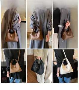Detail view of leather bucket bags showing metal turn-lock and texture in four colors