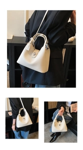 Close-up of beige lychee grain leather bucket bag with silver metal swivel clasp