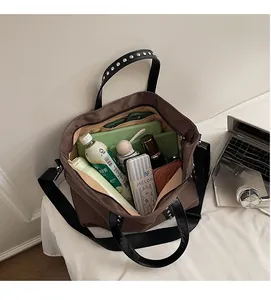 Close-up of the spacious brown tote bag interior showing various daily essentials