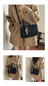 Quilted black bucket bag with beaded charm accessory shown in multiple carrying ways