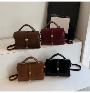 Detailed display of vintage matte leather handbags in dark brown, burgundy, and tan colors