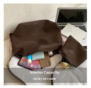 Detail view of large brown suede tote bag showing internal storage for iPad and makeup