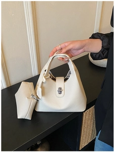 Detail of cream lychee leather handbag with silver twist lock and matching coin purse