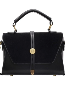 Minimalist black matte crossbody bag with gold hardware and faux suede texture flap