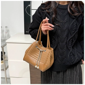 Detail of woven brown PU leather bucket bag with pearl drawstring and chain strap handle