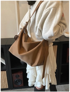 Brown suede tote bag side view showing large capacity and adjustable leather strap