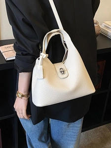Chic off-white lychee texture leather tote bag with metallic buckle and shoulder strap