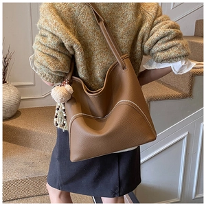 Brown litchi leather tote bag with silver zippers and cute plush bear keychain charm