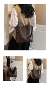 Detail of dark brown vintage bucket bag showing fine leather texture and soft structure