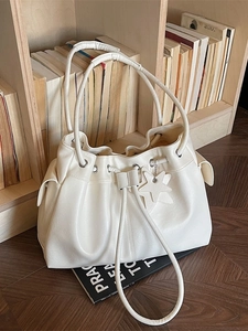 Elegant off-white drawstring bucket bag with star pendant and soft pleated texture