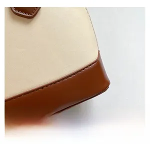 Close-up of premium pebbled leather stitching and dual-tone contrast of shell bag