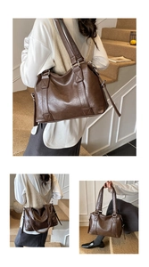 Detailed side view of deep brown vintage tote bag with wide straps and textured leather