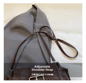 Detail of vintage brown shoulder bag with adjustable strap and silver metal buckle