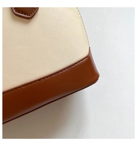 Detail shot of the reinforced base stitching on this vintage two-tone shell handbag
