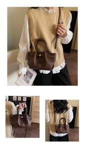 Detail view of dark brown lychee pattern leather tote bag with golden metal buckle