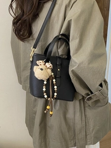 Black litchi grain leather bucket bag with cute bear charm and bohemian bead tassel