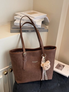 Vintage dark brown tote bag with adjustable straps and cute plush bear charm decoration