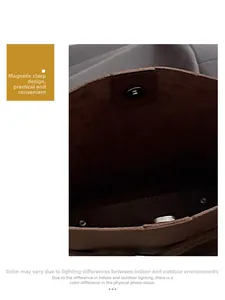 Close-up of magnetic snap closure on brown suede hobo bag showing practical detail