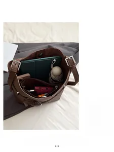 Top view of large brown pebble leather bucket bag showing spacious interior with essentials