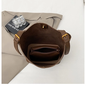 Overhead view showing brown lychee leather bucket bag with a matching zipper inner pouch