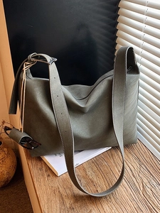 Large grey-green faux suede tote bag with white stitching and adjustable strap