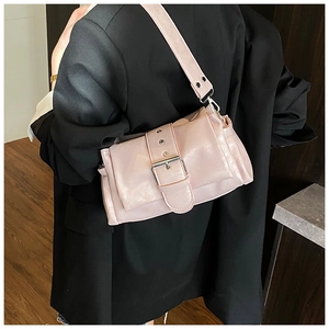 Detailed view of a pink pleated leather bag with oversized silver metal buckle design