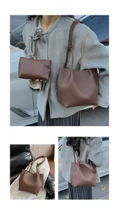 Detail view of large caramel brown lychee pattern leather tote bag and matching pouch